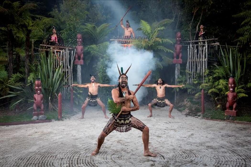 Image of a Maori warrior performing a welcome powhiri at Tamaki Maori Village