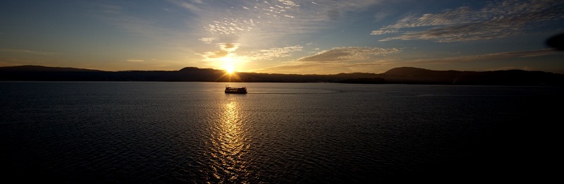 Lakeland Queen cruising Lake Rotorua at sunset. 