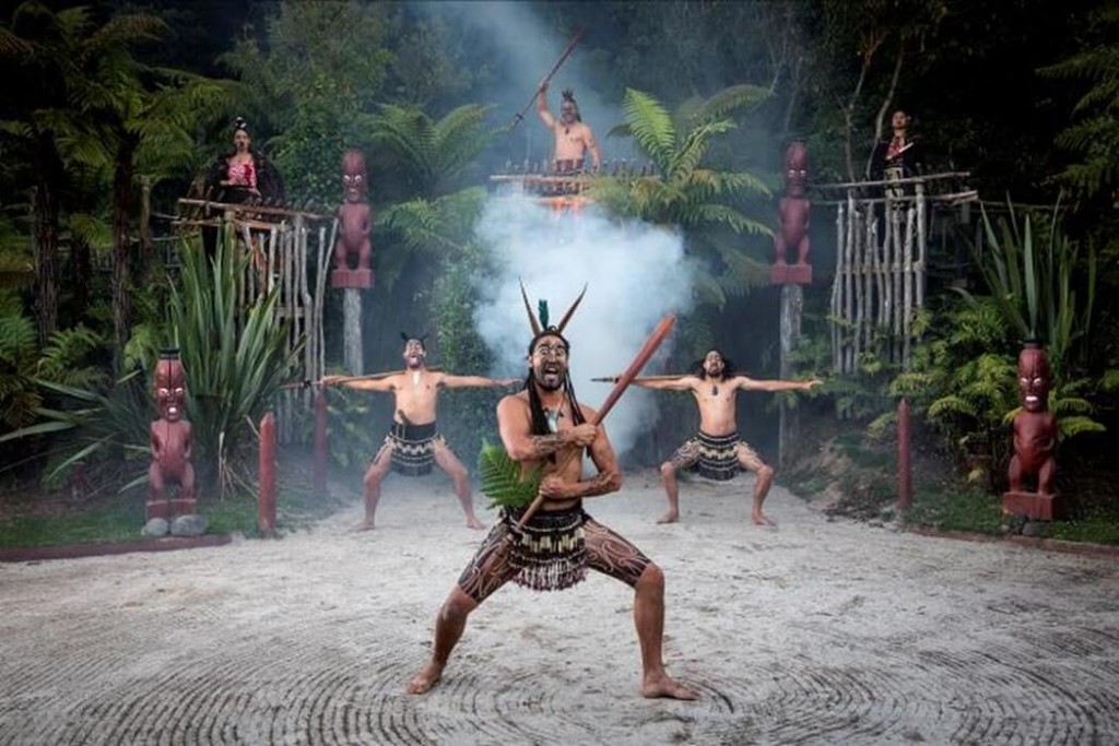 Image of a Maori warrior performing a welcome powhiri at Tamaki Maori Village