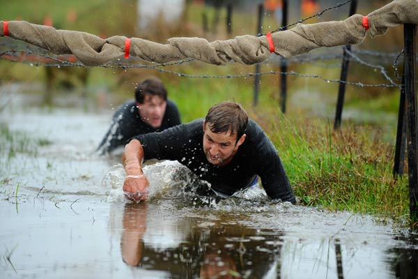 Crawling through mud is an integral part of the Tough Guy & Gal Challenge