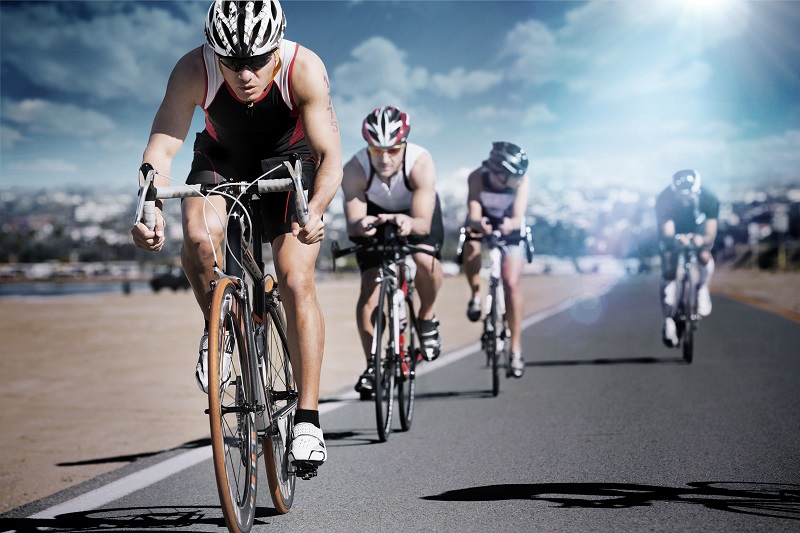 Triathletes cycling on street in the World Masters Games