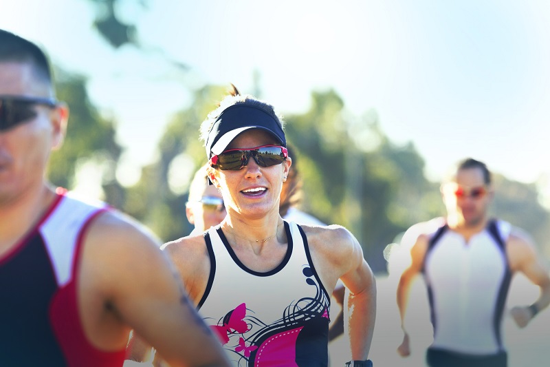 Female athlete with competitors running in race at the World Masters Games