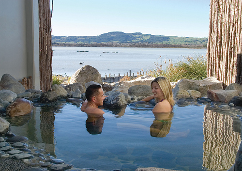 A couple relax in the waters of the Polynesian Spa