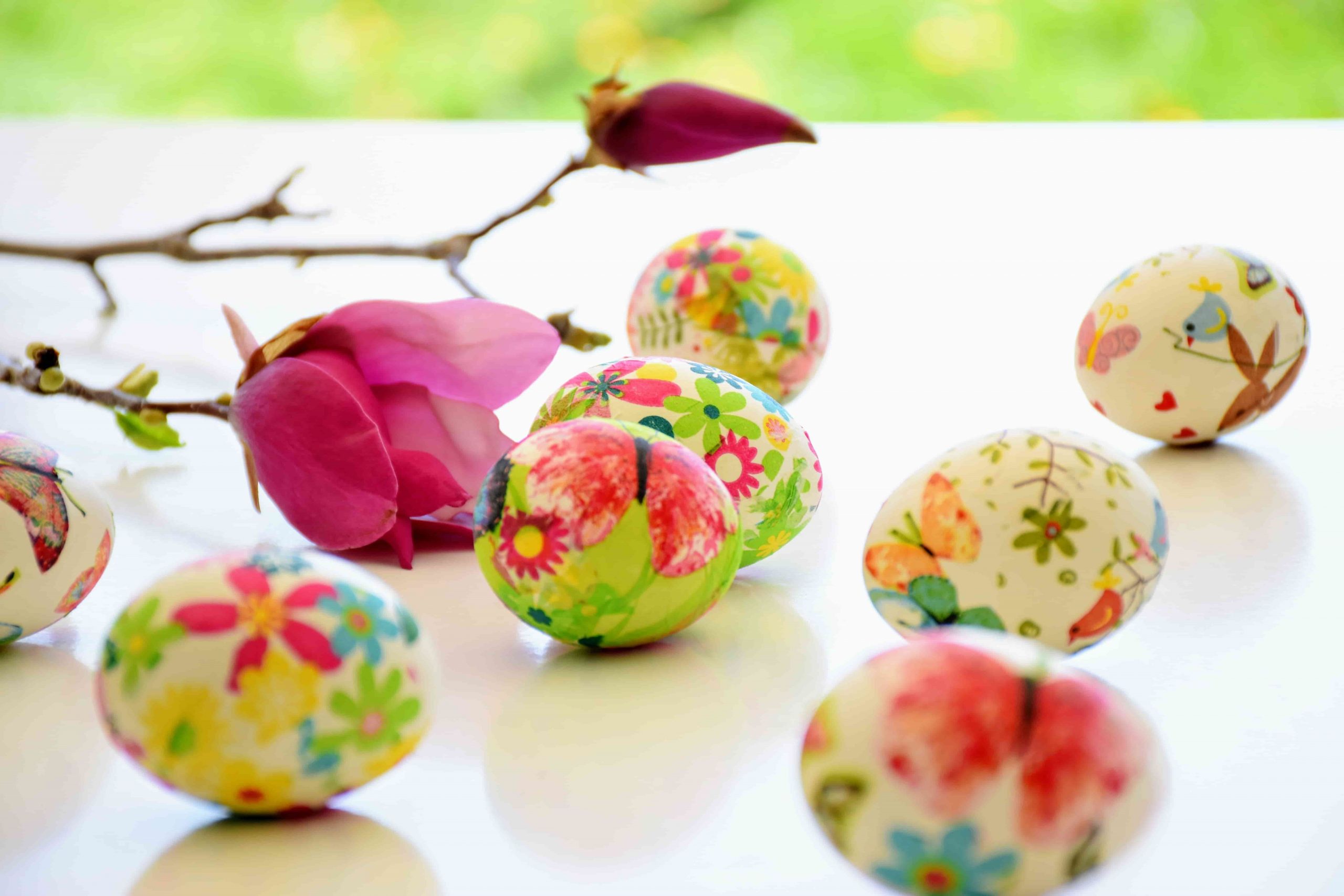 Painted eggs on table with flowers